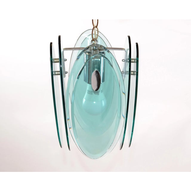 Mid-Century Modern Italian beveled thick glass and chrome pendant light fixture by Fontana Arte from the 1970s. The...