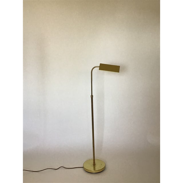 This vintage brass reading lamp blends function and character with its adjustable arm design and naturally tarnished brass...