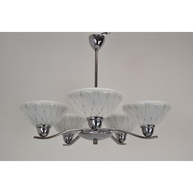 Made in czechoslovakia. Made of glass, metal, chrome. The chandelier was completely dasassembled and cleaned. Fitted with...