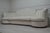 A sophisticated statement sofa combining a gently arched, diamond-tufted backrest with sculptural channelled arms and...