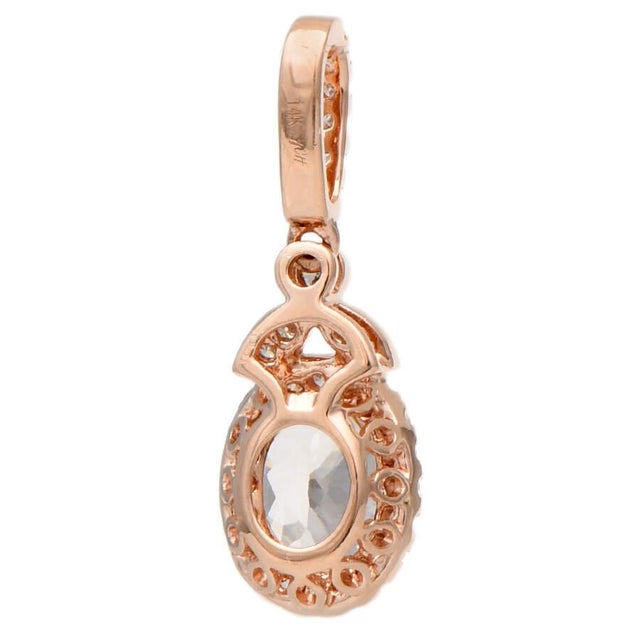 This enchanting, morganite halo pendant boasts surrounding diamonds in a delicate and dainty pave-and-bead setting of...