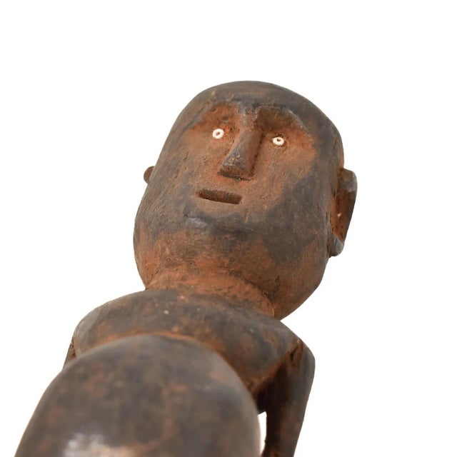 The Azande miniature figure was hand-carved by the Azande artisans of the Democratic Republic of the Congo, but the Azande...