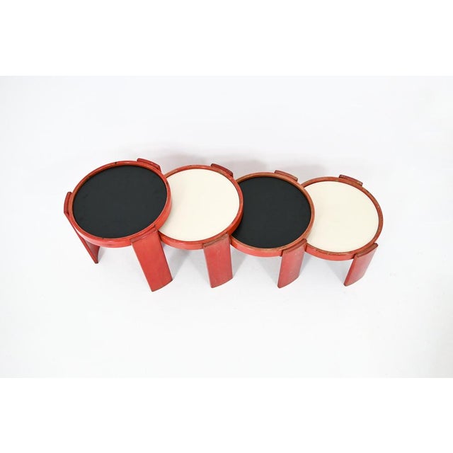 Wooden nesting table. Reversible black and white top. Stamped Cassina. Wear due to time and age of the table. Measures:...