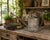 A beautifully weathered galvanized steel watering can dating to the 1940s, featuring a gracefully arched copper handle,...