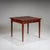 Elegant folding table featuring tall, fluted, tapering legs and a narrow drawer integrated into the otherwise smooth...