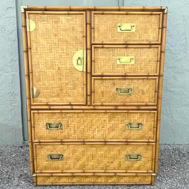 striking vintage highboy dresser by Dixie featuring woven herringbone wicker panels framed in warm faux bamboo. This tall...