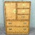 striking vintage highboy dresser by Dixie featuring woven herringbone wicker panels framed in warm faux bamboo. This tall...