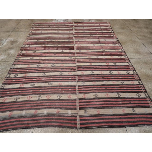 A vintage Turkish flatweave Kilim room size carpet handmade during the mid-20th century. Measures: 9' 10" x 14' 0".
