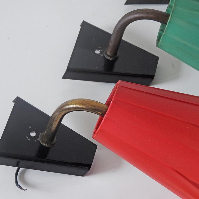 Four vintage wall lamps. Conical shades covered with nylon raffia in various colors (red, green, ivory, pastel orange)....