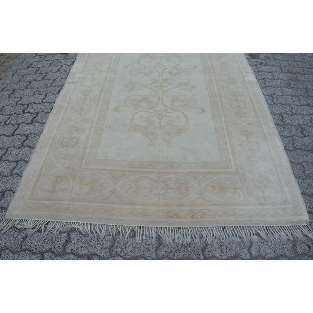 This is a vintage Turkish Oushak rug from the 1960s. The piece was hand-knotted.