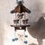 decorative wooden wall shelf resembles a vintage carousel, featuring a canopy top, three cut-out carousel horses adorned...
