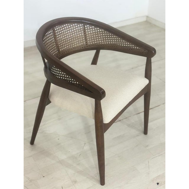 For sale is a stylish armchair made of elegant dark wood, featuring a semi-circular backrest with classic wickerwork and a...