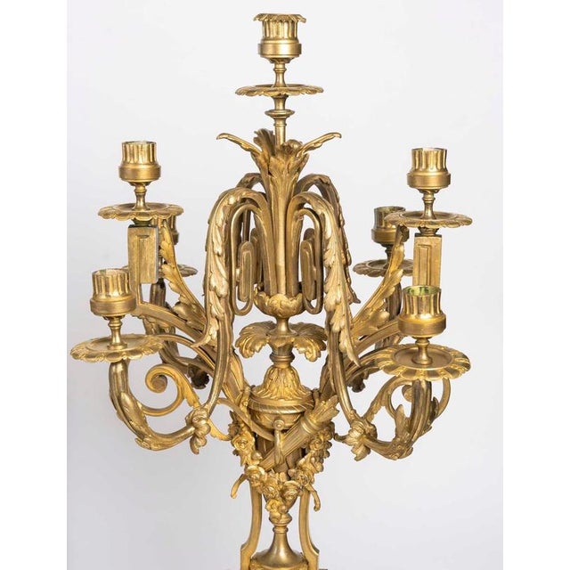 Napoleon iii-era gilded bronze mantelpiece set. Mantelpiece set consisting of a clock and two candelabra in gilded bronze...