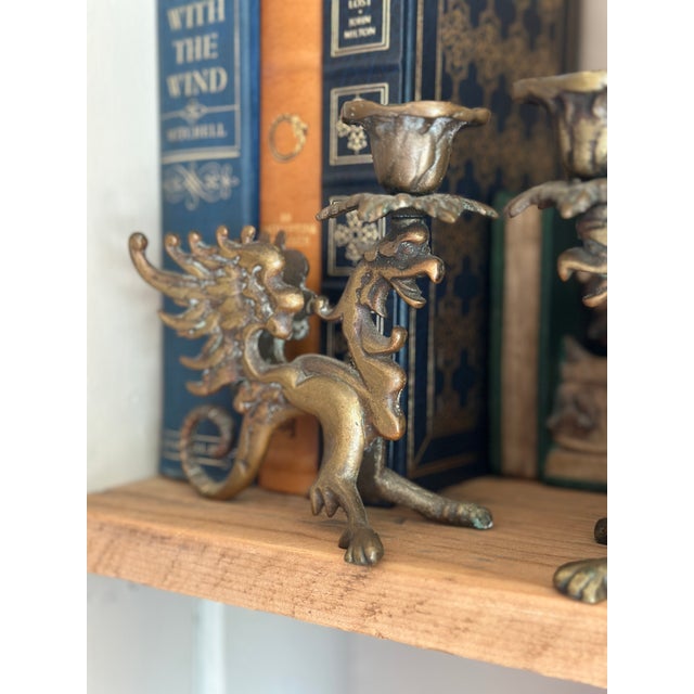 A fantastic pair of late 19th or early 20th-century solid brass candlesticks. Each holder is cast in the detailed form of...