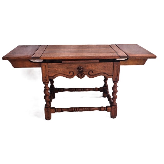 A beautifully preserved piece of early 20th‑century craftsmanship, this 1930s draw‑leaf coffee table by the Cochran Chair...