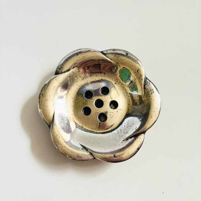 A mid century silver plated candle holder in the shape of a flower. Meant to hold 5 tiny taper candles. Made in Japan by...