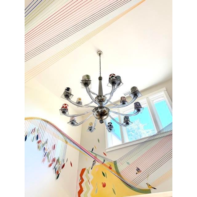 This stunning, hand-blown Murano chandelier showcases a luxurious smoky grey glass design, perfect for making a bold...