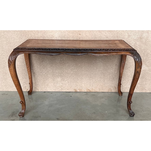 A fantastic antique walnut coffee table in the Queen Anne Style. This was made in England, it dates from around the...