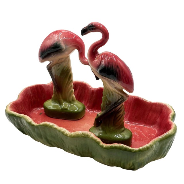 Mid-century set of 2 pink and green flamingo ceramic figurines with flamingo pool tray decorative bowl. The set features...
