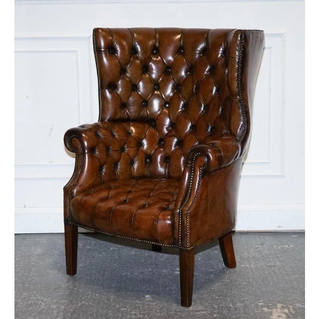Elevate your interior with this luxurious restored Chesterfield Porter’s Wingback Armchair, expertly upholstered in...