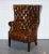 Elevate your interior with this luxurious restored Chesterfield Porter’s Wingback Armchair, expertly upholstered in...
