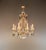 This antique chandelier captivates with its diverse crystal ornamentation and combination of various materials....