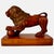 This beautifully carved wood lion stands in a classic pose, with one paw resting on an orb, atop a rectangular plinth. It...