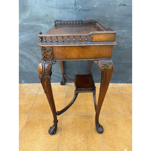 Elegant Louis XV style carved wood side table featuring a refined gallery top and gracefully curved cabriole legs. Richly...
