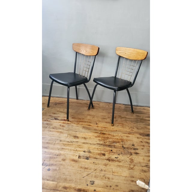 Refurbished Howell Metal Dining Chair Pair. c. 1960's. Tubular steel frame with refinished maplewood and bronze tone metal...