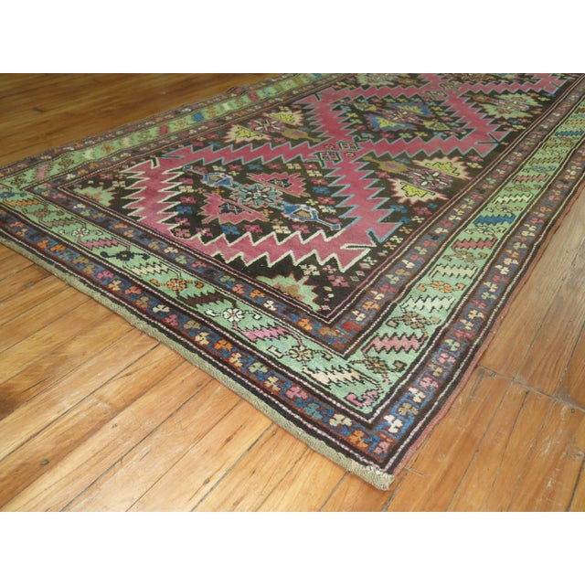 Vintage Karabagh runner predominant accents in pink and chartreuse on a brown colored ground. 3'10'' x 12'9'' Karabagh are...