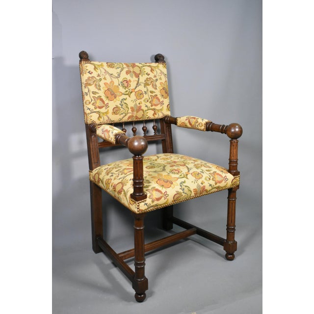 Constructed in solid walnut, this impressive chair displays finely turned front legs, elegant arm supports, bulbous hand...