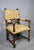 Constructed in solid walnut, this impressive chair displays finely turned front legs, elegant arm supports, bulbous hand...