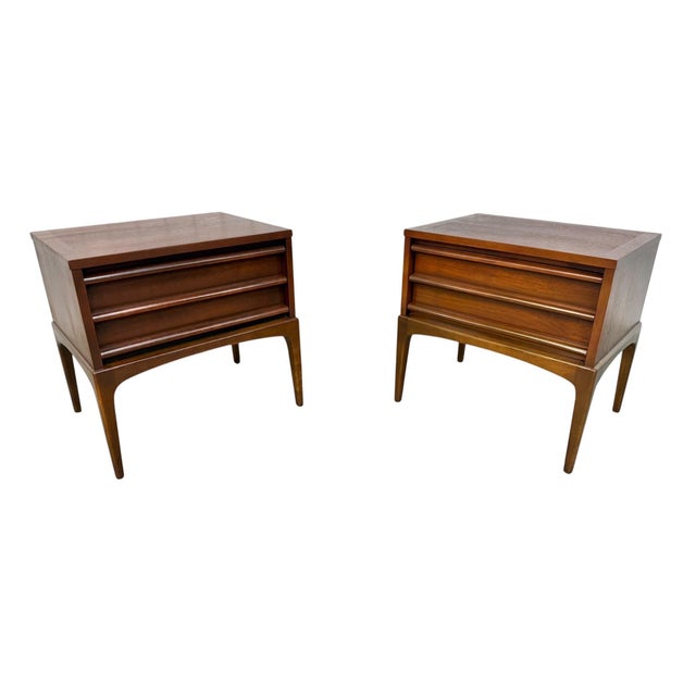 Add timeless mid-century style to your space with this stunning pair of Lane Rhythm walnut nightstands, circa 1960s....