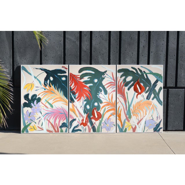 "Tropical Abundance IIII" is a botanical painting triptych by Romina Milano where a dance of tropical flowers unfolds...