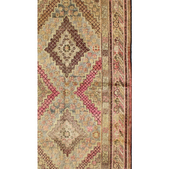 Measures: 4'2 x 7'10. Early 20th century antique Khotan rug with paired diamond medallions in wine red. Keivan Woven Arts...