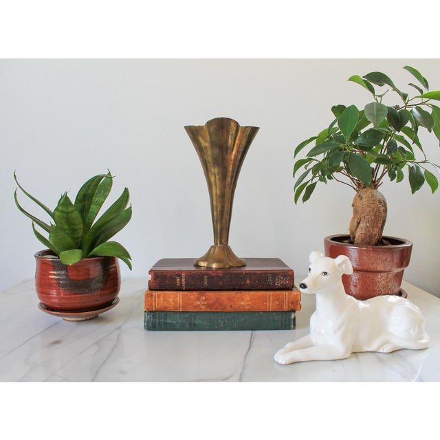 Vintage brass fluted trumpet vase with a scalloped rim and pedestal base. No makers mark. Patina.