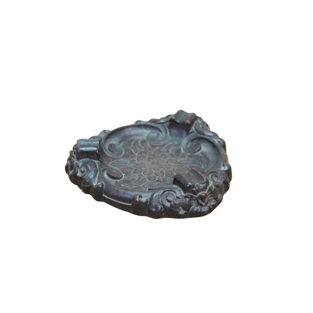 This vintage Syroco wood ashtray features a triangular shape with heavily molded, ornate details characteristic of the...