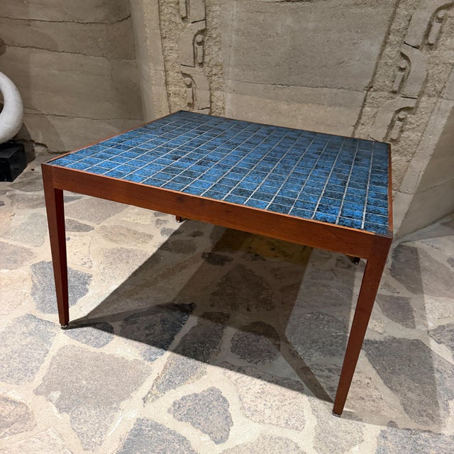 For your consideration, a mid-century modern Danish accent table features a rich wood frame inlaid with a vibrant blue...
