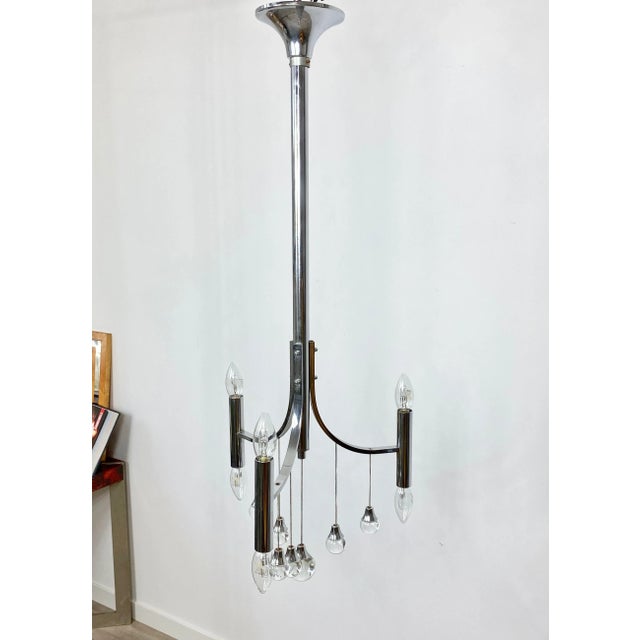 Mid-Century chrome frame six lights chandelier pendant by the Italian designer Gaetano Sciolari. Beautifully decorated...