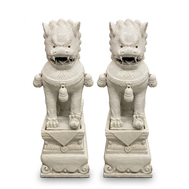 Elevate your interior decor with this magnificent matching pair of large, vintage ceramic Foo Dog guardian statues....