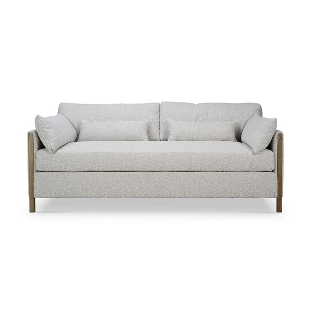This exquisite sofa features a sleek, modern frame upholstered in premium boucle sand fabric. The solid wood accents,...