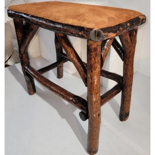 Early Old Hickory bench with suede seat newly upholstery and in strong ,sturdy condition.