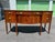 Elegant mahogany sideboard has a serpentine front with decorative wood inlays. This piece features three top drawers and...