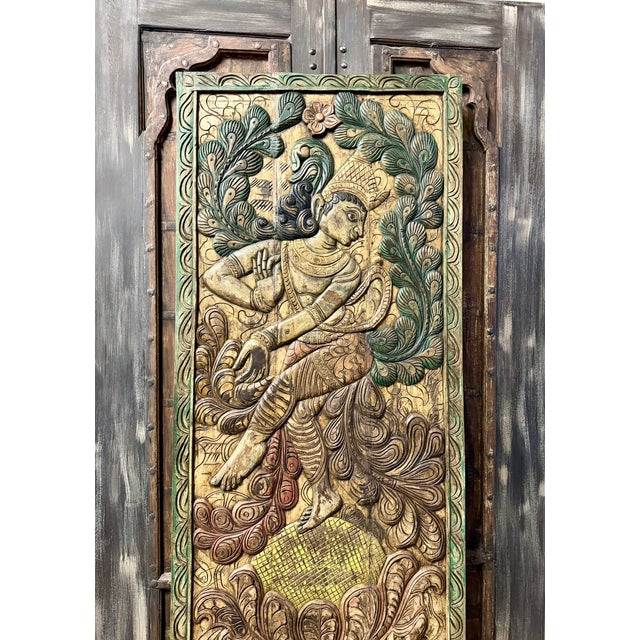 Celebrate the divine beauty of Indian craftsmanship with this Vintage Colorful Dancing Krishna Carved Wood Door Panel....