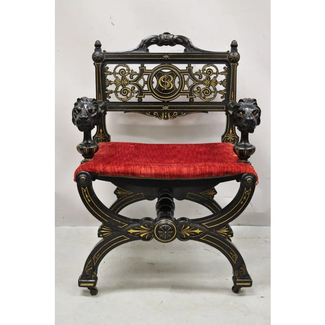 Antique Victorian Aesthetic Movement Ebonized Curule Throne Arm Chair with Lions. Item features Lion carved armrests,...