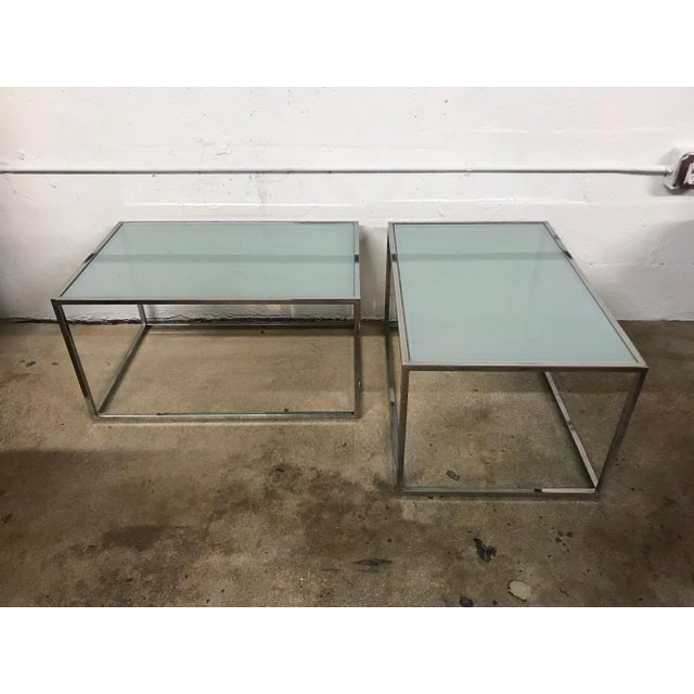 Set of two Thinline coffee cocktail side or end tables by Mid Baughman rendered in chrome-plated steel with frosted glass...