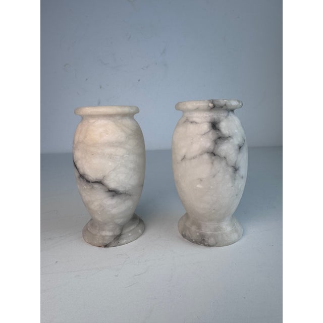 Offering a pair of small hand carved alabaster vases. Set them among your collectibles.