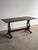 This vintage old world oak dining table features a sculptural trestle base with pierced pedestal supports, exposed joinery...