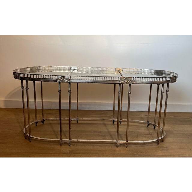 This very beautiful and unique neoclassical style coffee table is made of silver plated brass with antique mirror...