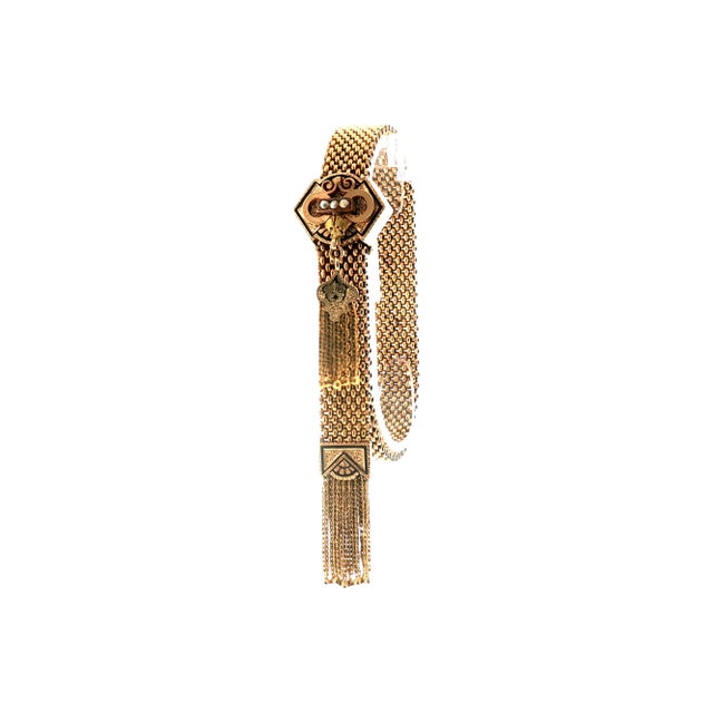 A Victorian bracelet crafted from 10k yellow gold. Features a mesh design with intricate detailing. Adorned with white...